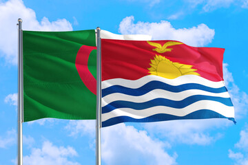 Fototapeta na wymiar Kiribati and Algeria national flag waving in the windy deep blue sky. Diplomacy and international relations concept.