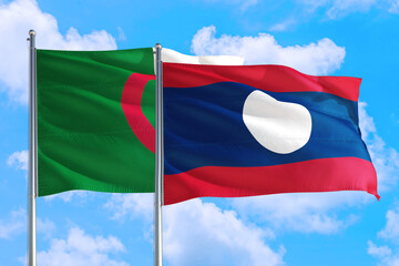 Fototapeta na wymiar Laos and Algeria national flag waving in the windy deep blue sky. Diplomacy and international relations concept.