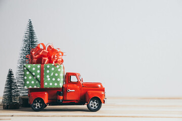 Red Christmas truck with pine tree and gift. Merry Christmas and happy new year concept.