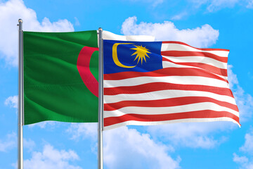 Malaysia and Algeria national flag waving in the windy deep blue sky. Diplomacy and international relations concept.
