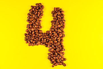 Numbers made with coffee grains on a yellow background.