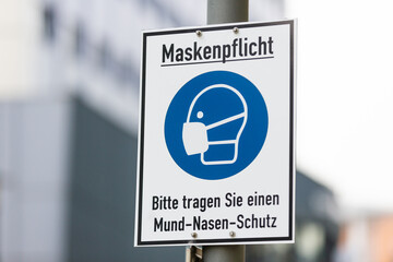 Info sign in a german city with german text. Maskenpflicht, Bitte tragen Sie einen Mund-Nasen-Schutz. Mask compulsory, please wear mouth and nose protection.