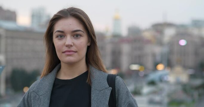 Young woman look at the camera. Cinema 4K 60fps video