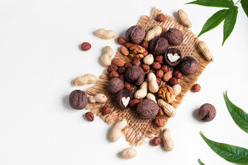 Almonds, walnuts, hazelnuts and peanuts, mix of nuts. Contains beneficial vitamins and minerals. On a gray background.