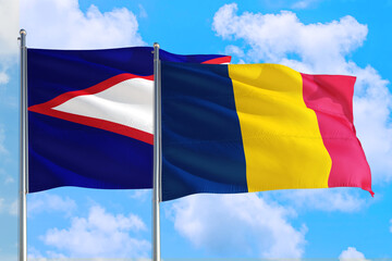Chad and American Samoa national flag waving in the windy deep blue sky. Diplomacy and international relations concept.