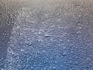 Water drops on the roof of the car. Weather changes