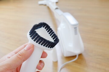 His hand and Her hand holding the equipment for the Vacuum cleaner/Woman use vacuum cleaner. Close up.