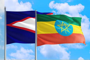 Ethiopia and American Samoa national flag waving in the windy deep blue sky. Diplomacy and international relations concept.