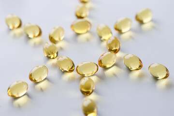 Shiny fish oil nutrition, omega 3,6,9 for good health lie in the shape of the sun closeup. Prevention of rickets regular intake of vitamin D concept.