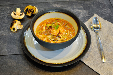 Delicious home cooked food with steam on table on brown background