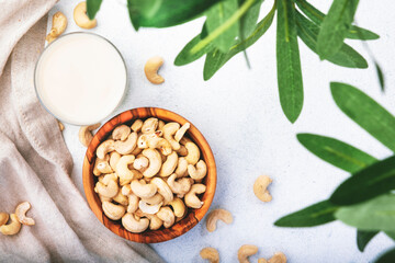 Vegan Cashew nut milk on white background. Non dairy alternative vegan milk. Healthy vegetarian food and drink. Copy space, top view