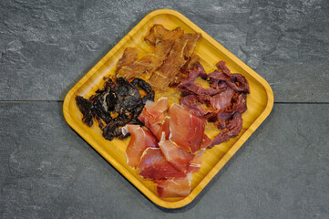 Slices of french Saucisson sausage with glass of beer