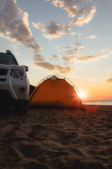Fototapeta na wymiar suv car near tent at sandy beach. camping lifestyle