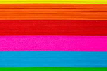 Multicolored sticky notes stacked in a pile. Evenly lit by artificial light