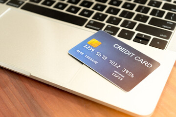 Close-up of the blue credit card on laptop keyboard. Concept of internet purchase