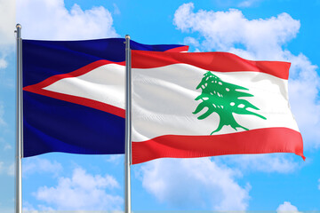 Lebanon and American Samoa national flag waving in the windy deep blue sky. Diplomacy and international relations concept.