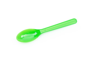 Green plastic spoon isolated on white background.