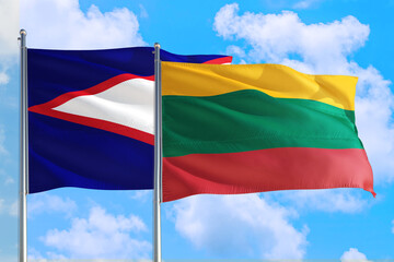 Fototapeta na wymiar Lithuania and American Samoa national flag waving in the windy deep blue sky. Diplomacy and international relations concept.