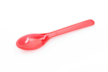 Red plastic spoon isolated on white background.