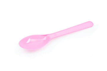 Pink plastic spoon isolated on white background.