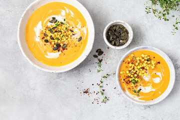 Pumpkin and vegetables cream soup with pumpkin seeds and crackers