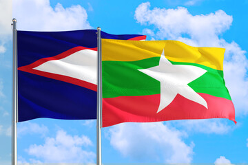 Myanmar and American Samoa national flag waving in the windy deep blue sky. Diplomacy and international relations concept.