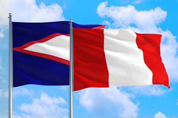 Fototapeta na wymiar Peru and American Samoa national flag waving in the windy deep blue sky. Diplomacy and international relations concept.