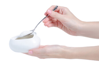 White sugar bowl with teaspoon in hand on white background isolation
