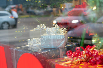 Photo through glass. Shop window, decorations and New Year's gifts.