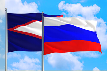 Russia and American Samoa national flag waving in the windy deep blue sky. Diplomacy and international relations concept.