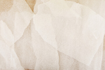 White plastic foam sheet pieces on cardboard background. Closeup of torn foam polyethylene pieces.