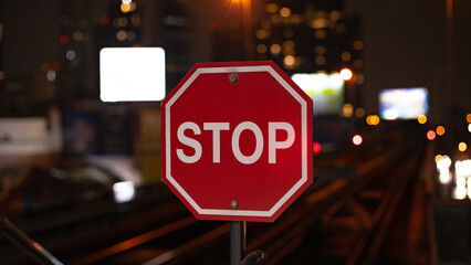 Stop Sign on Train Tracks at night