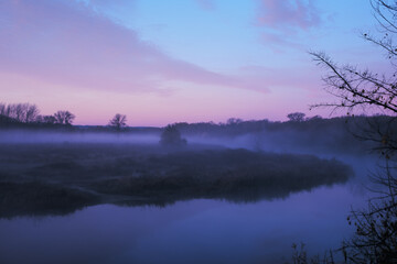 Autumn fog in the early morning over the river