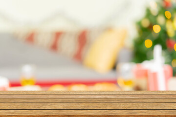 abstract blur decorated christmas ornament pine tree in home interior background with wood perspective tabletop for show,ads,design product on display concept in merry xmas and happy new year