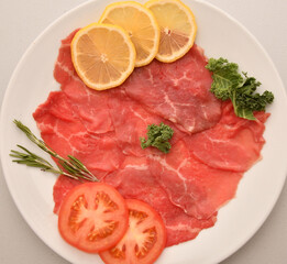 Carpaccio dish of thinly sliced pieces (slices) raw beef tenderloin 