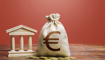 Euro money bag and bank / government building. Tax collection and budgeting. State debt. GDP and...