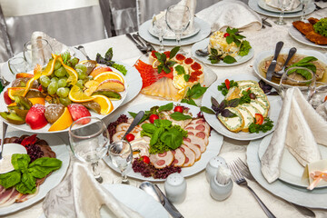 catering table set service with silverware and glass stemware at restaurant before party