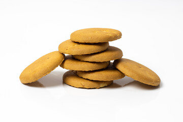 A pile of delicious rounded wheat biscuits isolated on reflective white background