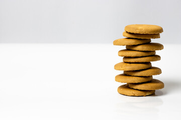 Fototapeta na wymiar A pile of rounded wheat biscuits isolated at the right side of a white empty background