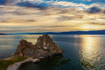 Majestic landscape with Shamanka Rock at Olkhon Island on Baikal lake, Siberia, Russia. Summer vacation in the heart of Siberia.The sacred place of Buddhists and shamans