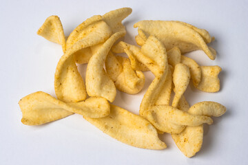 Delicious crispy scattered potato chips top view isolated on white background