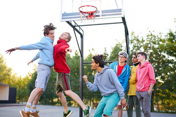 two basketball teams, rivals play with each other. young caucasian boys confront, want to win. at...