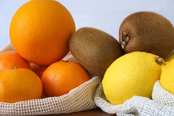 tangerines, oranges, lemons and kiwis in a bag