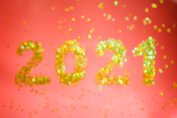 Blurry 2021 numbers banner. Golden glitters. Red background. New Year wallpaper