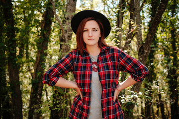 traveler hipster woman standing alone in autumn woods .