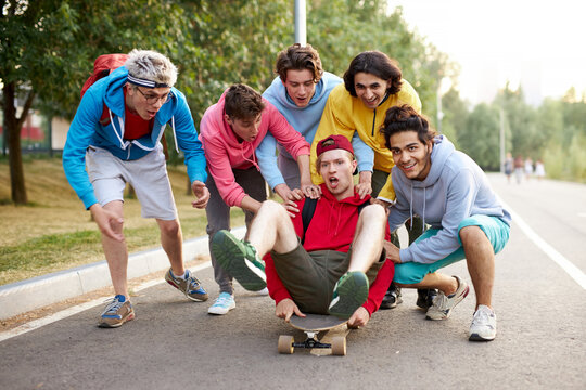 happy teenagers skateboarder boys have fun outdoors, caucasian youth generation freetime spending concept image