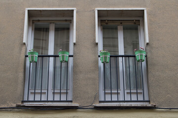 facade with two vertical twin balconies and two green pots on each