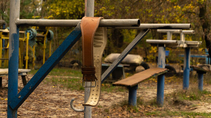 leather sports belt hanging on the uneven bars
