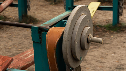leather belt for weightlifting on vintage old barbell