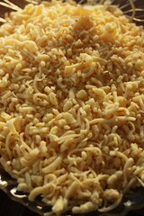 Fresh grated cheese on a plate macro